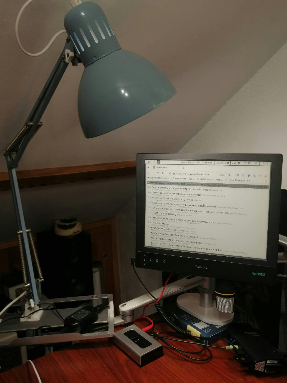 A lamp shining on an e-ink monitor